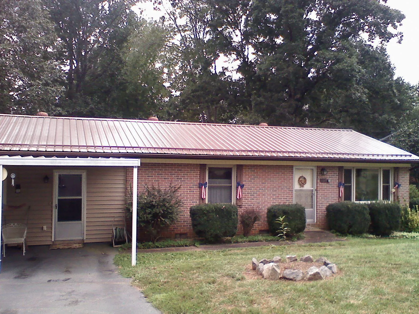 Bronze metal roof and carport on a brick ranch home — Roof Repair work by our crew in Spangle
